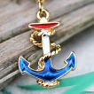 Piercing nombril doré avec ancre de marine bleu blanc rouge