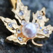 Piercing nombril doré feuille d'érable à perle