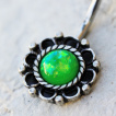 Piercing nombril fleur antique à Opale