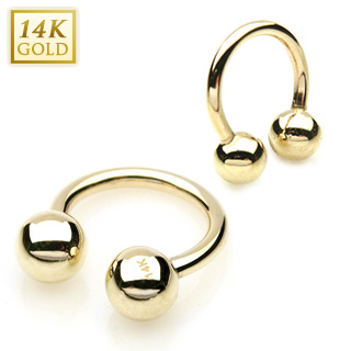 Piercing fer  cheval  boules en or jaune 14 carats